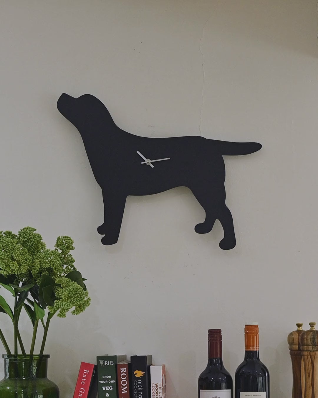 Black Labrador clock on a kitchen wall, tail wagging